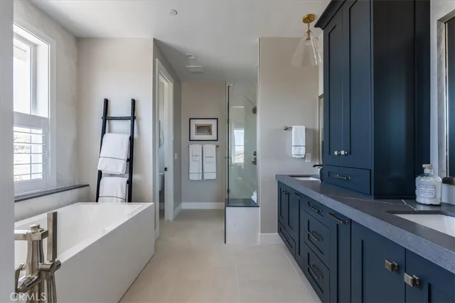 a spacious bathroom with a double vanity sink and a mirror