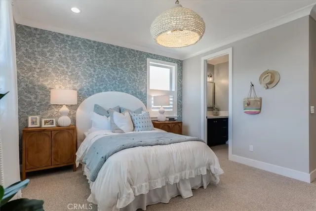 a bedroom with a bed and painting on the wall