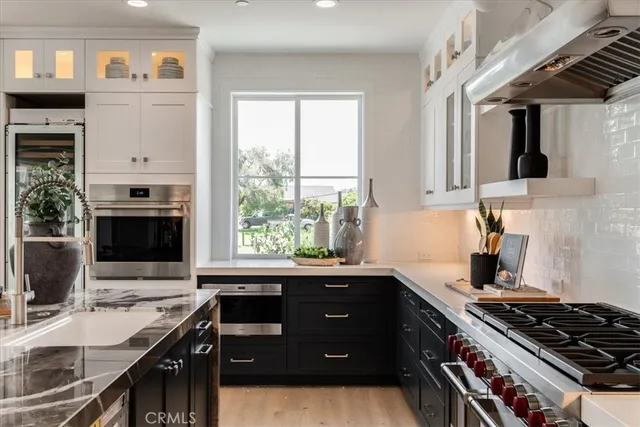 a kitchen with stainless steel appliances a stove sink and cabinets