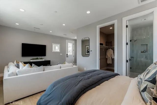 a bathroom with a granite countertop sink a toilet a shower and a mirror