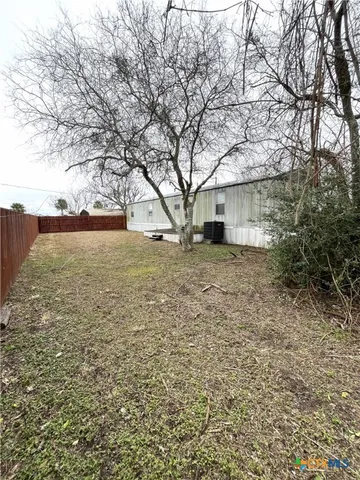 a view of yard with large trees
