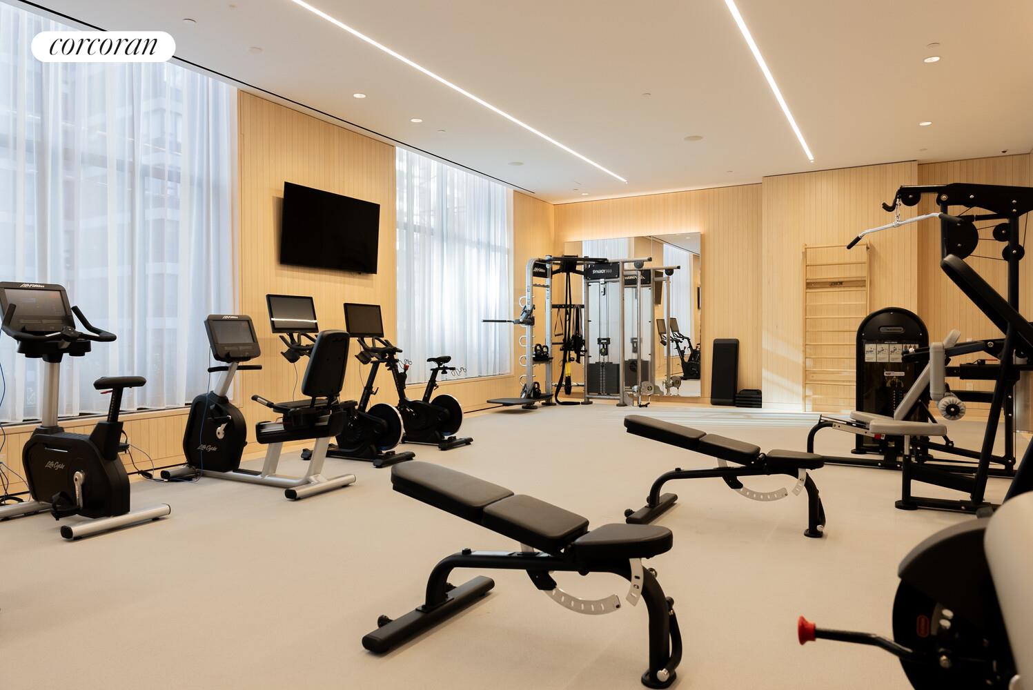 430 East 58th Street, Unit 70 Manhattan, NY 10022 - Photo 14 of 24 a view of a room with gym equipment