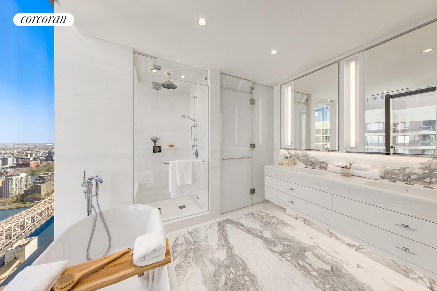 430 East 58th Street, Unit 70 Manhattan, NY 10022 - Photo 8 of 24 a spacious bathroom with a double vanity sink a large mirror and shower