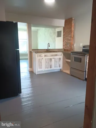 a kitchen with stainless steel appliances a sink and a refrigerator