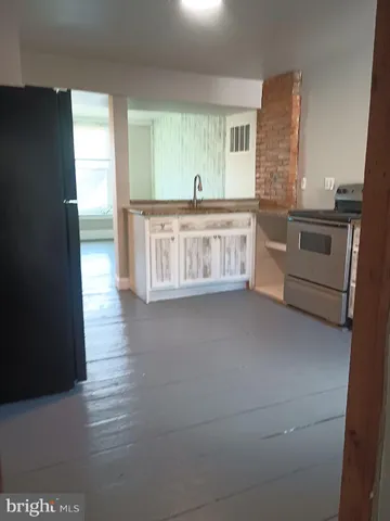 a kitchen with stainless steel appliances a sink and a refrigerator