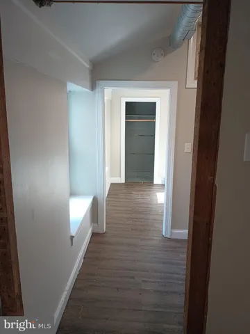 a view of hallway with wooden floor