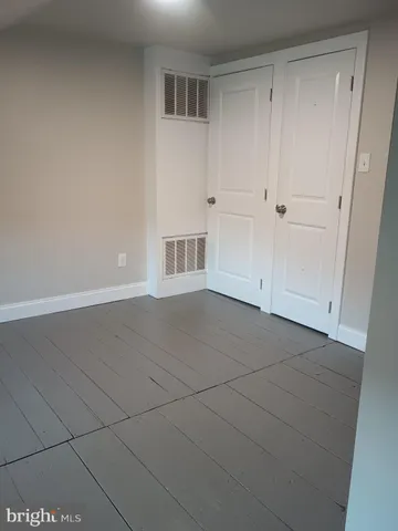 a view of empty room with white walls