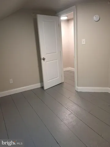 an empty room with an entrance and door
