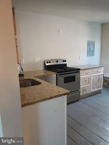 a kitchen with a stove and a sink