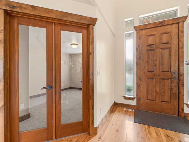 1279 West 1500th Street North Mapleton, UT 84664 - Photo 7 of 83 Solid wood entry door with transom window and sidelights, complemented by wood-finish flooring
