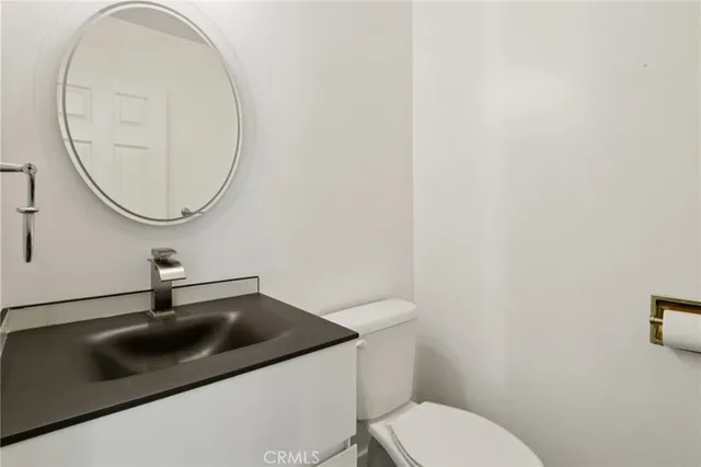 a bathroom with a sink a toilet and a shower