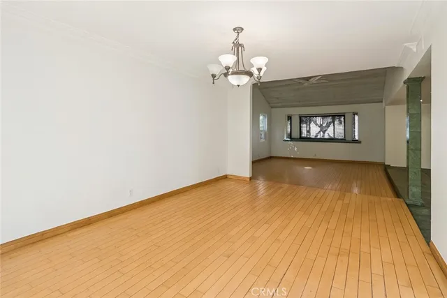 a view of a livingroom with wooden floor and a ceiling fan