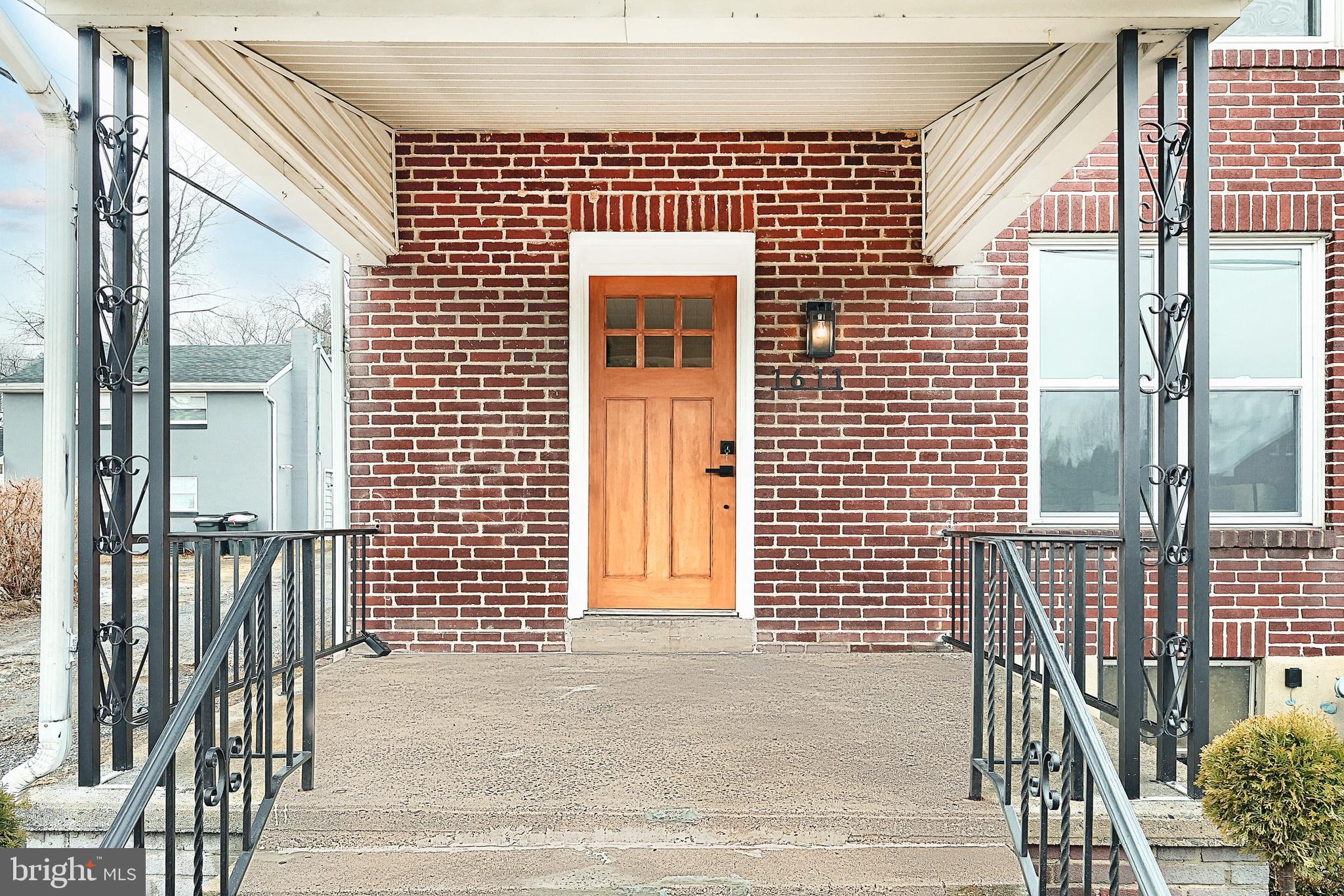 1611 Meade Street Reading, PA 19607 - Photo 11 of 59 a front view of a house with a glass door