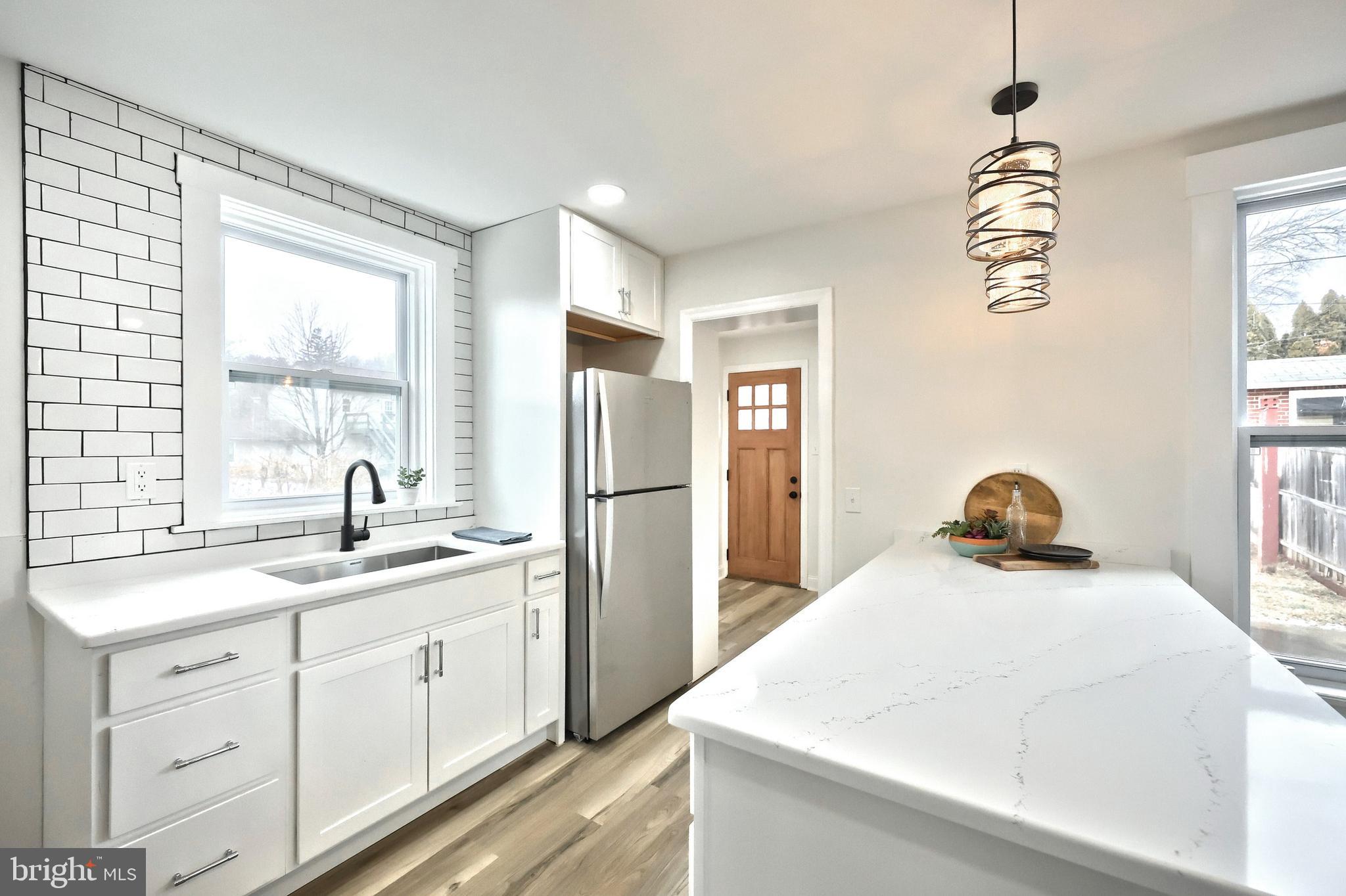 1611 Meade Street Reading, PA 19607 - Photo 21 of 59 a kitchen with a sink a stove and refrigerator