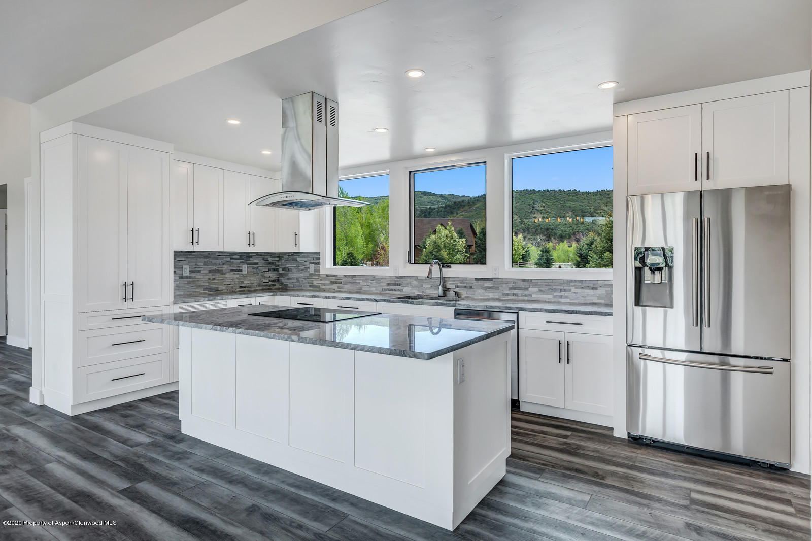 347 Equestrian Way Carbondale, CO 81623 - Photo 12 of 31 a kitchen with kitchen island granite countertop a sink appliances cabinets and a counter top space