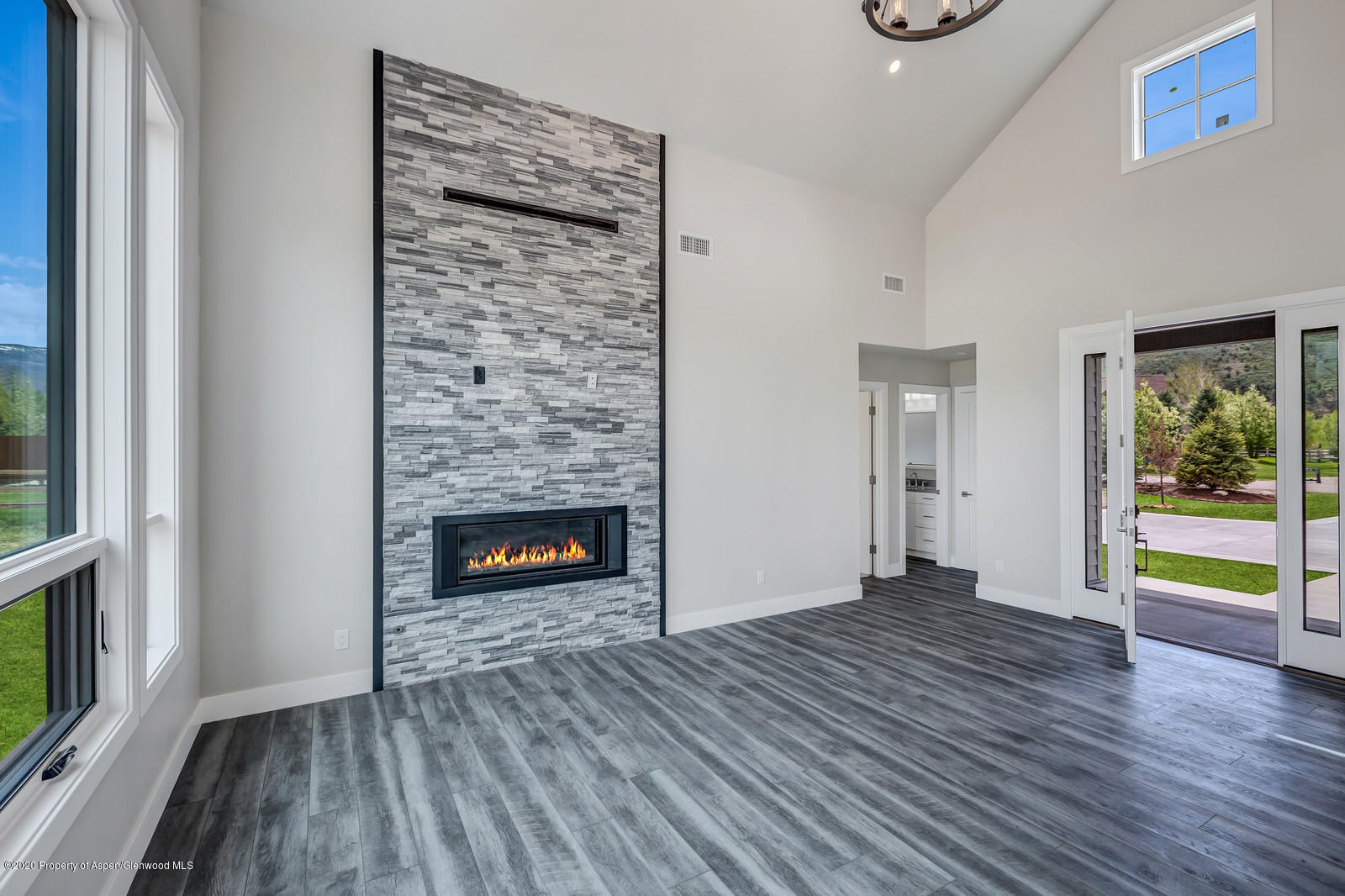 347 Equestrian Way Carbondale, CO 81623 - Photo 2 of 31 a view of an empty room with window wooden floor and fire place