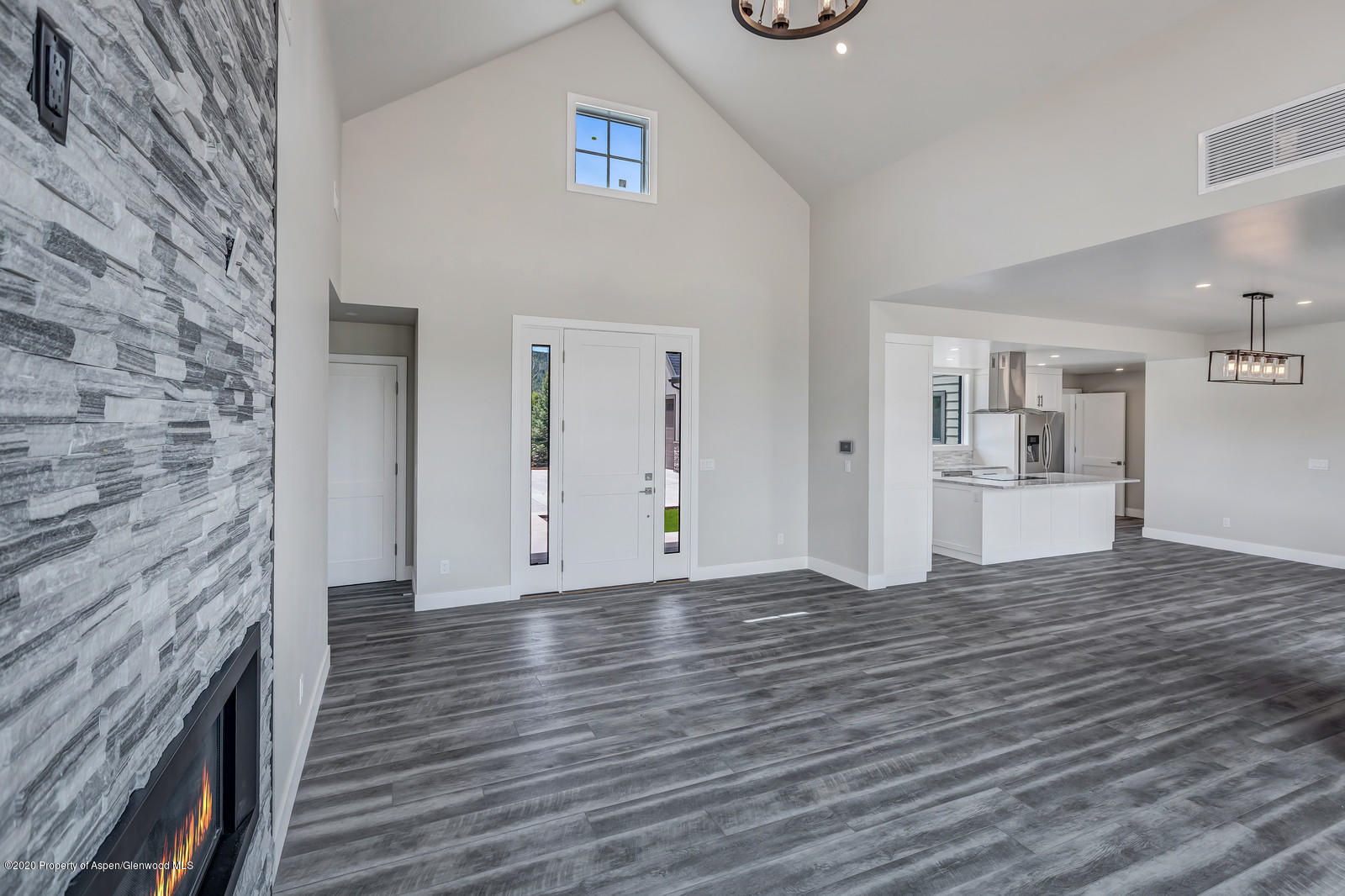 347 Equestrian Way Carbondale, CO 81623 - Photo 4 of 31 a view of empty room with wooden floor and kitchen