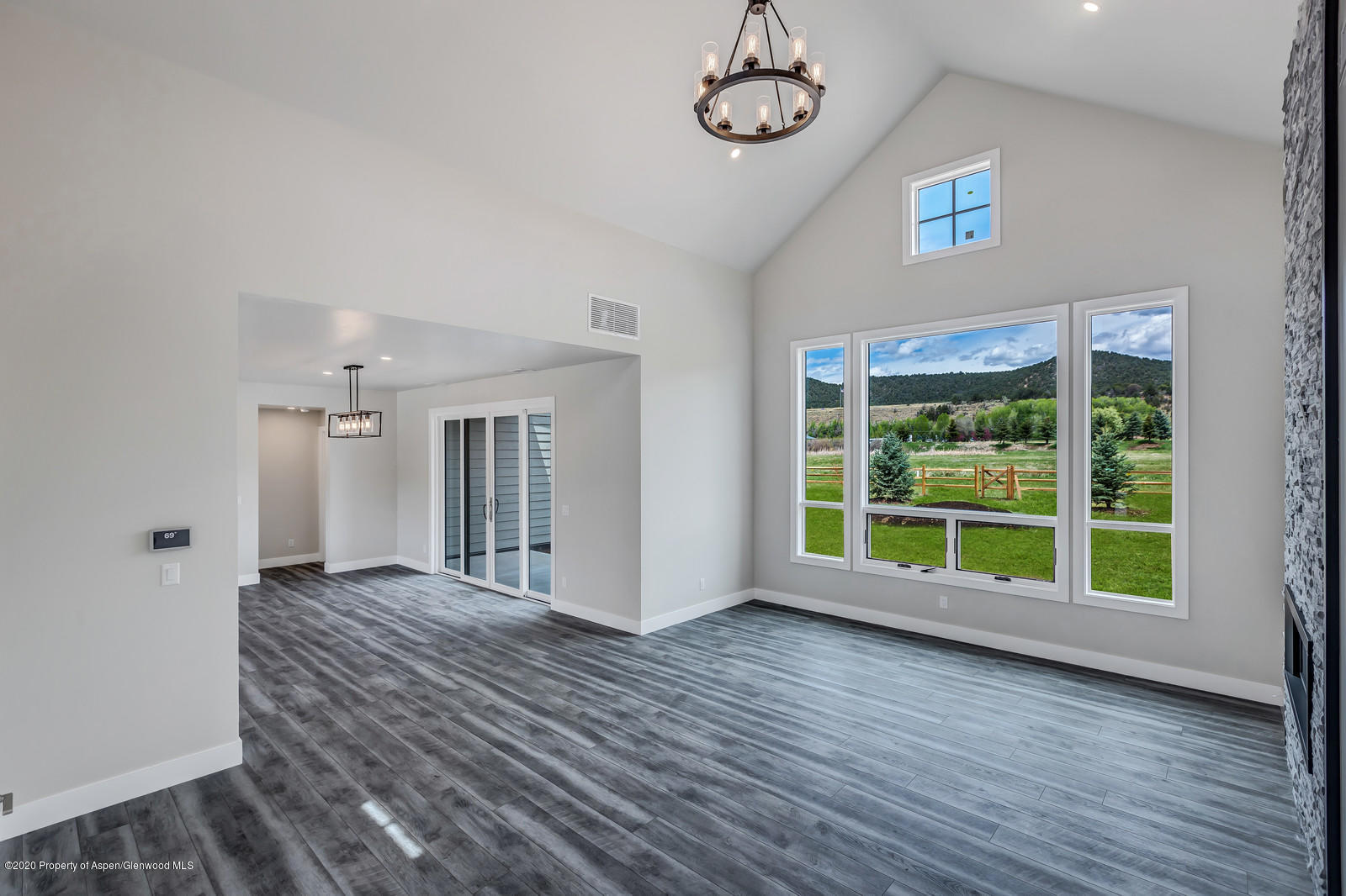 347 Equestrian Way Carbondale, CO 81623 - Photo 5 of 31 a view of an empty room with a window and wooden floor