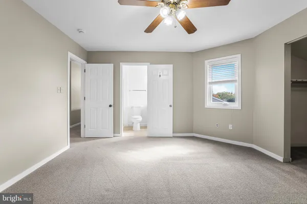 an empty room with windows and closet