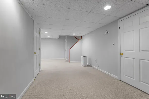 an empty room with white walls and stairs
