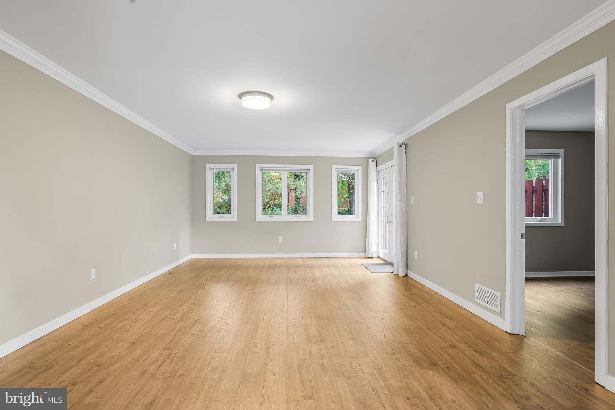 363 Chickory Way Newark, DE 19711 - Photo 3 of 17 a view of an empty room with wooden floor and a window