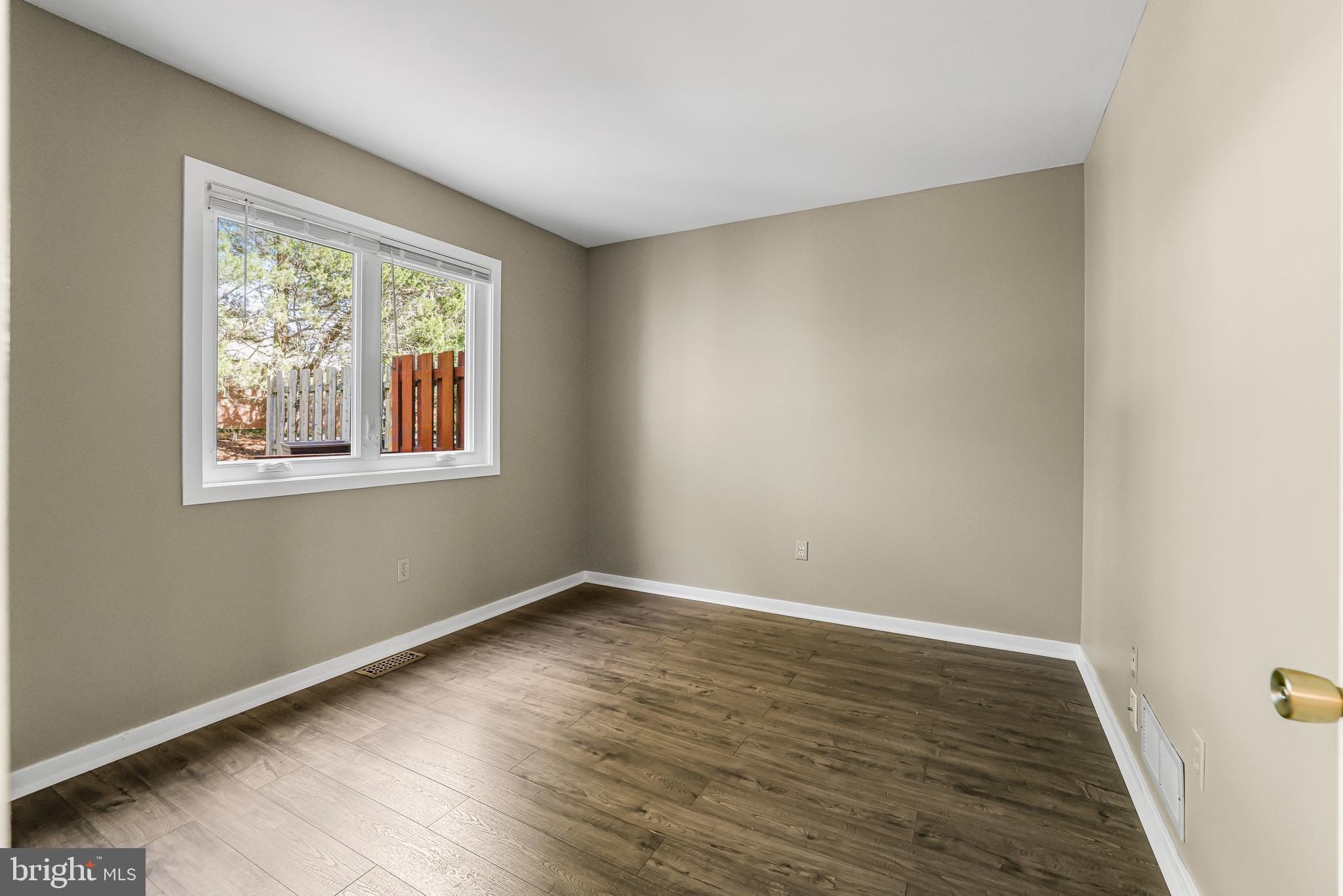 363 Chickory Way Newark, DE 19711 - Photo 4 of 17 a view of an empty room with wooden floor and a window