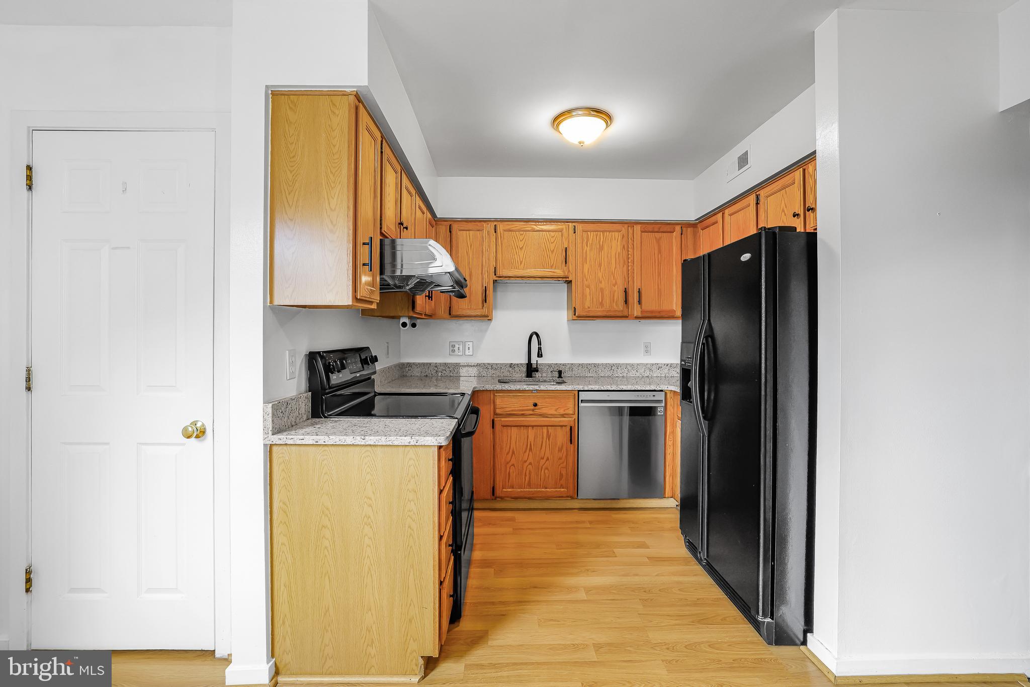 363 Chickory Way Newark, DE 19711 - Photo 5 of 17 a kitchen with a refrigerator a stove top oven and a sink