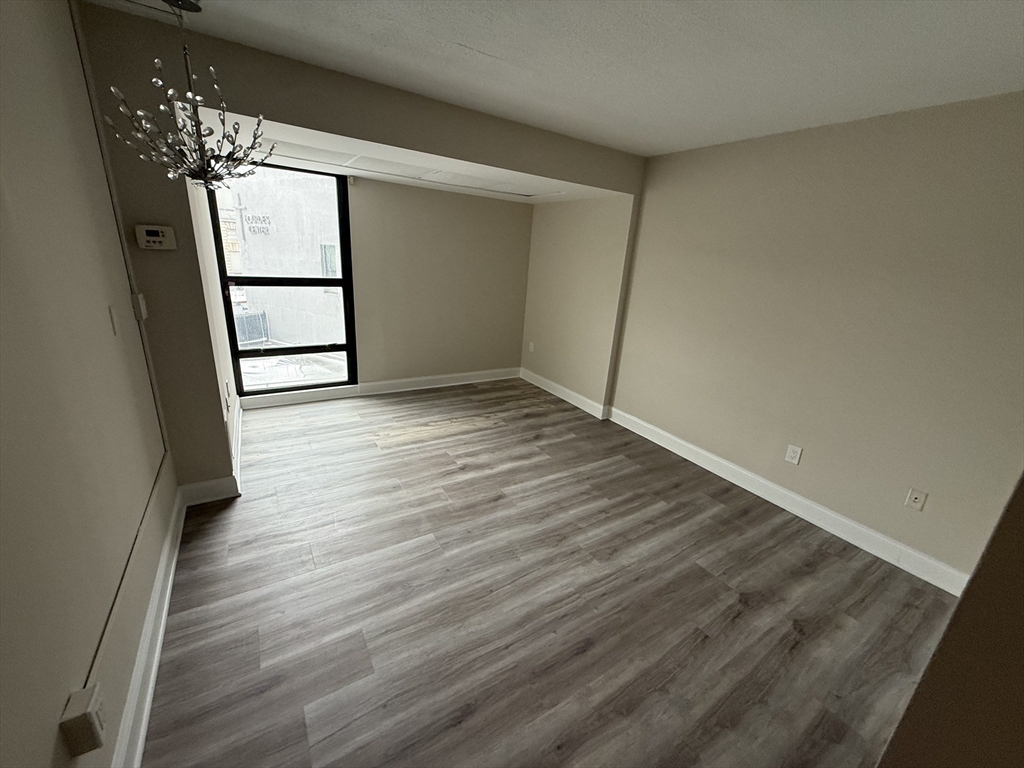 566 Commonwealth Avenue, Unit 308 Boston, MA 02215 - Photo 11 of 14 wooden floor in an empty room
