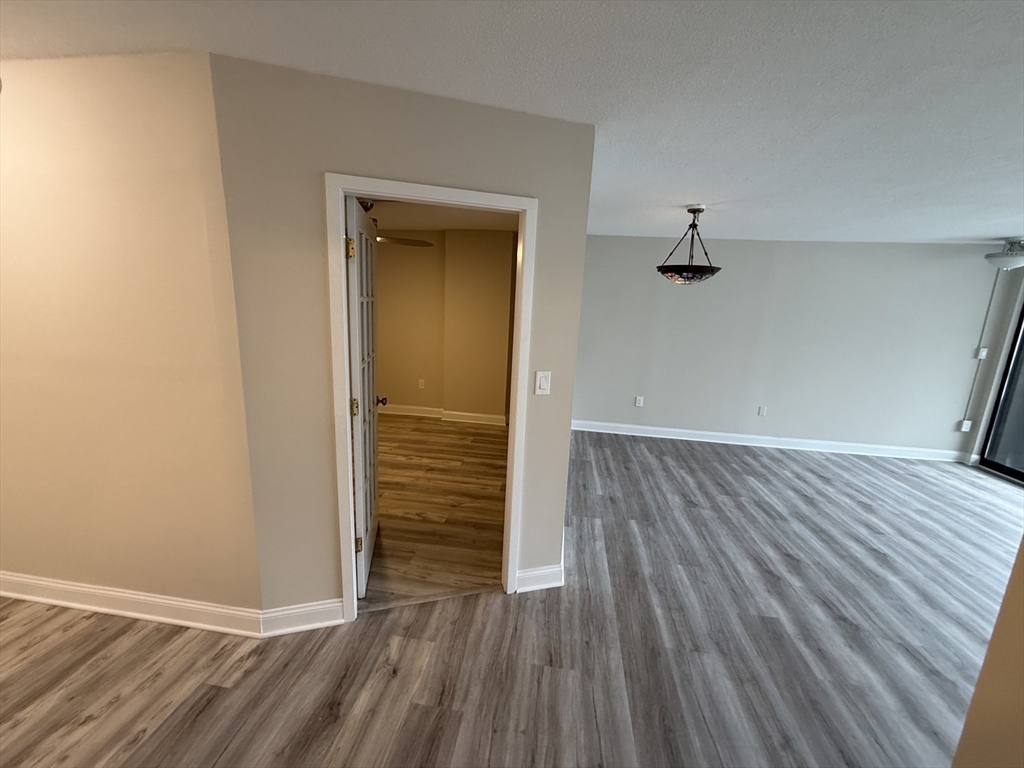 566 Commonwealth Avenue, Unit 308 Boston, MA 02215 - Photo 3 of 14 wooden floor in an empty room