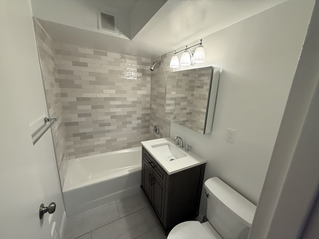 566 Commonwealth Avenue, Unit 308 Boston, MA 02215 - Photo 5 of 14 a bathroom with a sink a toilet and shower