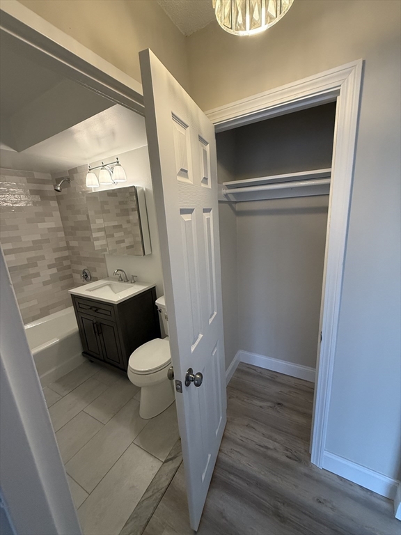 566 Commonwealth Avenue, Unit 308 Boston, MA 02215 - Photo 6 of 14 a bathroom with a toilet sink and mirror