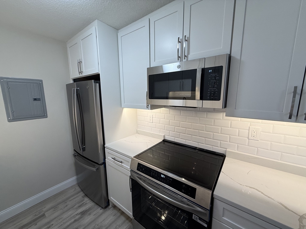 566 Commonwealth Avenue, Unit 308 Boston, MA 02215 - Photo 8 of 14 a kitchen with appliances and cabinets