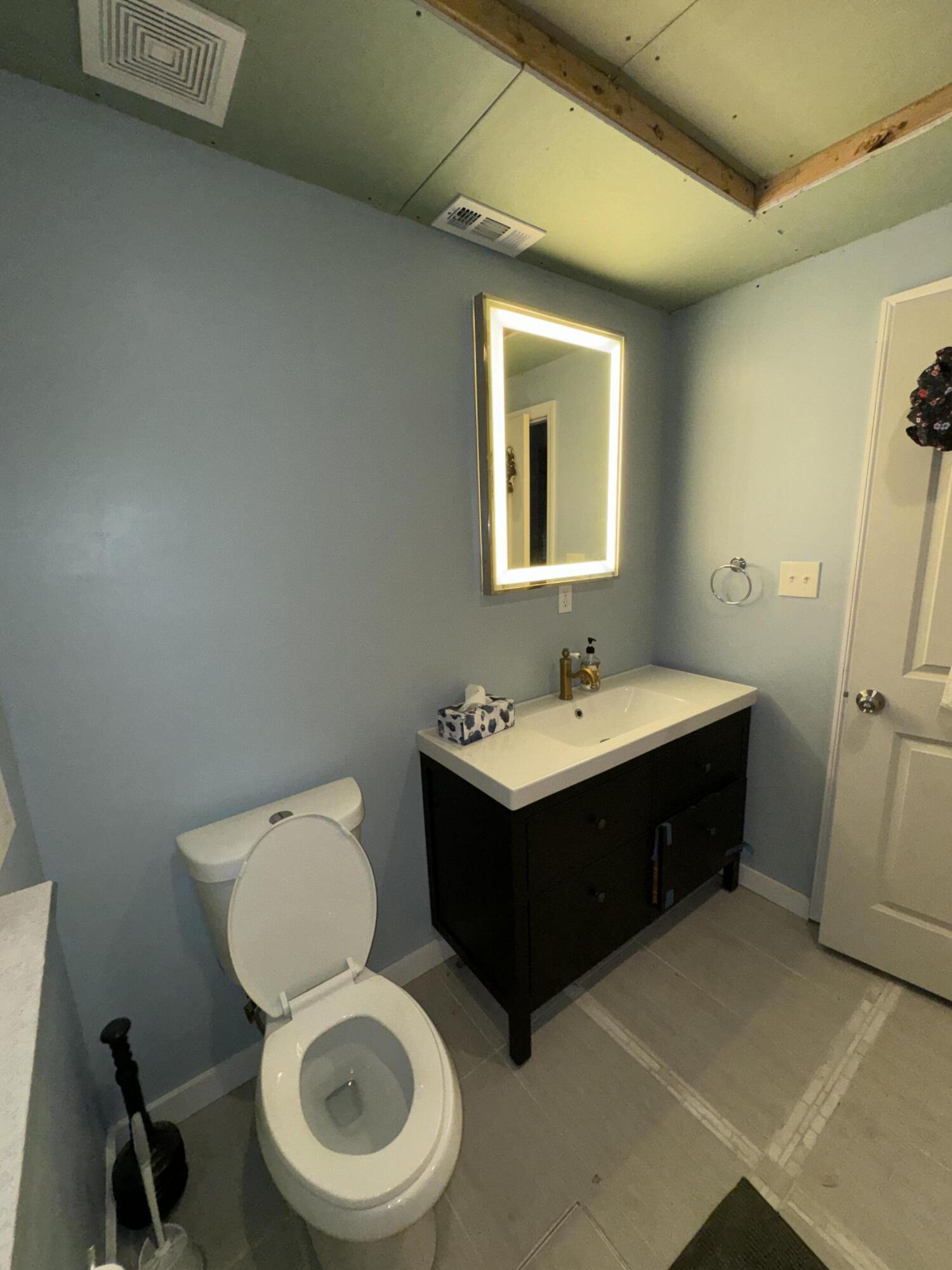 1825 Palm Boulevard Melbourne, FL 32901 - Photo 12 of 25 a bathroom with a sink toilet and a mirror