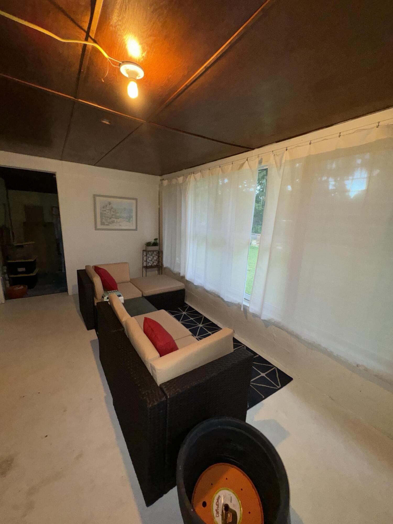 1825 Palm Boulevard Melbourne, FL 32901 - Photo 14 of 25 a bedroom with furniture and a window