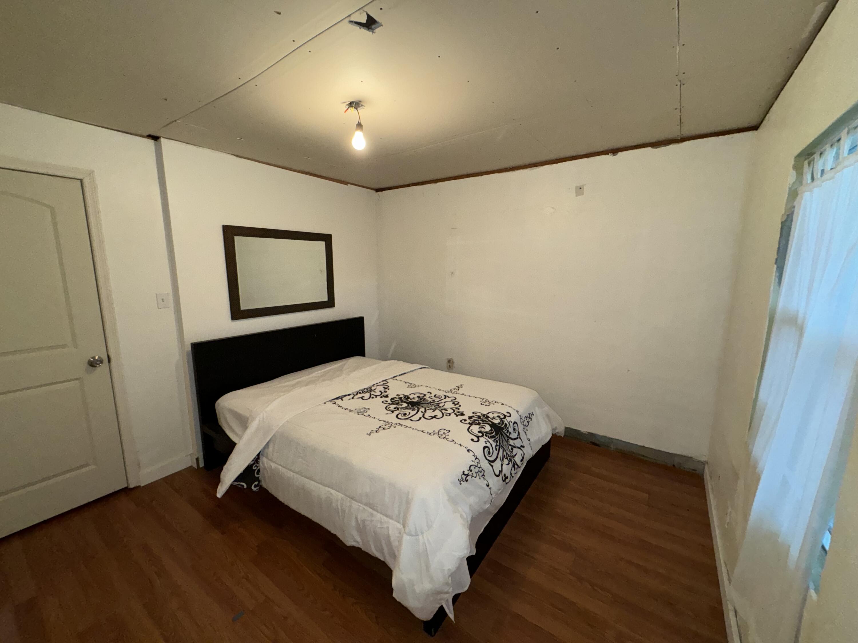 1825 Palm Boulevard Melbourne, FL 32901 - Photo 10 of 25 a bedroom with a bed and a window