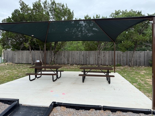 402 Judson Street Bertram, TX 78605 - Photo 26 of 27 a park bench sitting in the middle of a backyard