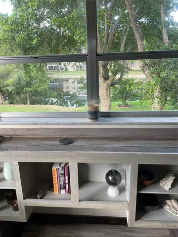 a kitchen with a sink a stove and wooden floor