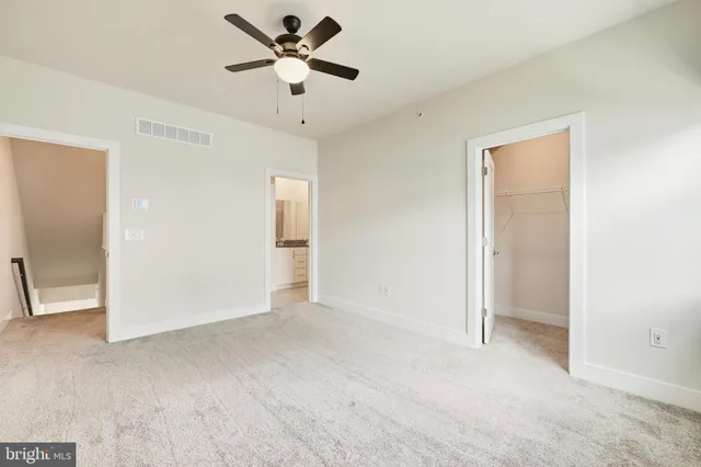 a view of an empty room and closet area