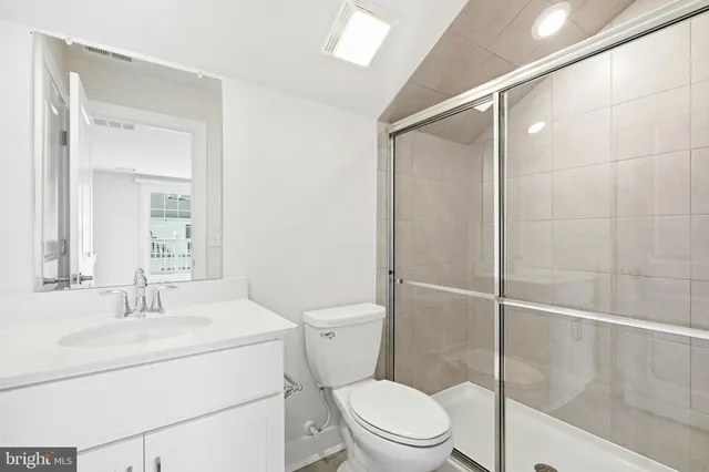 a bathroom with a toilet a sink and shower