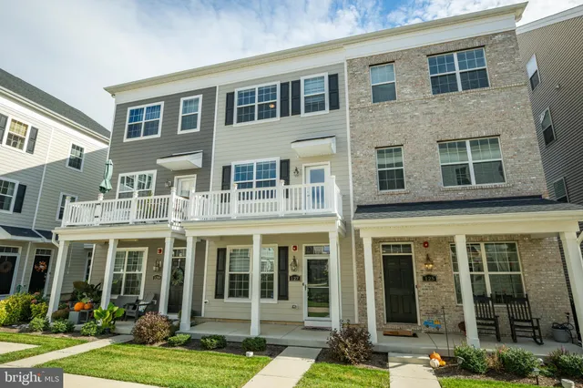 a front view of a residential apartment building with a yard