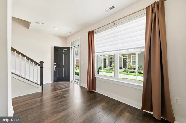a view of an entryway with wooden floor