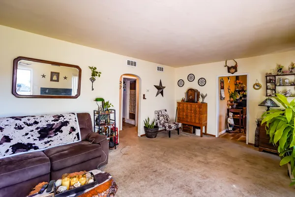 a living room with patio furniture and decor