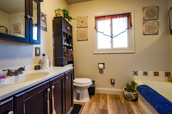 a bathroom with a sink a toilet and a mirror