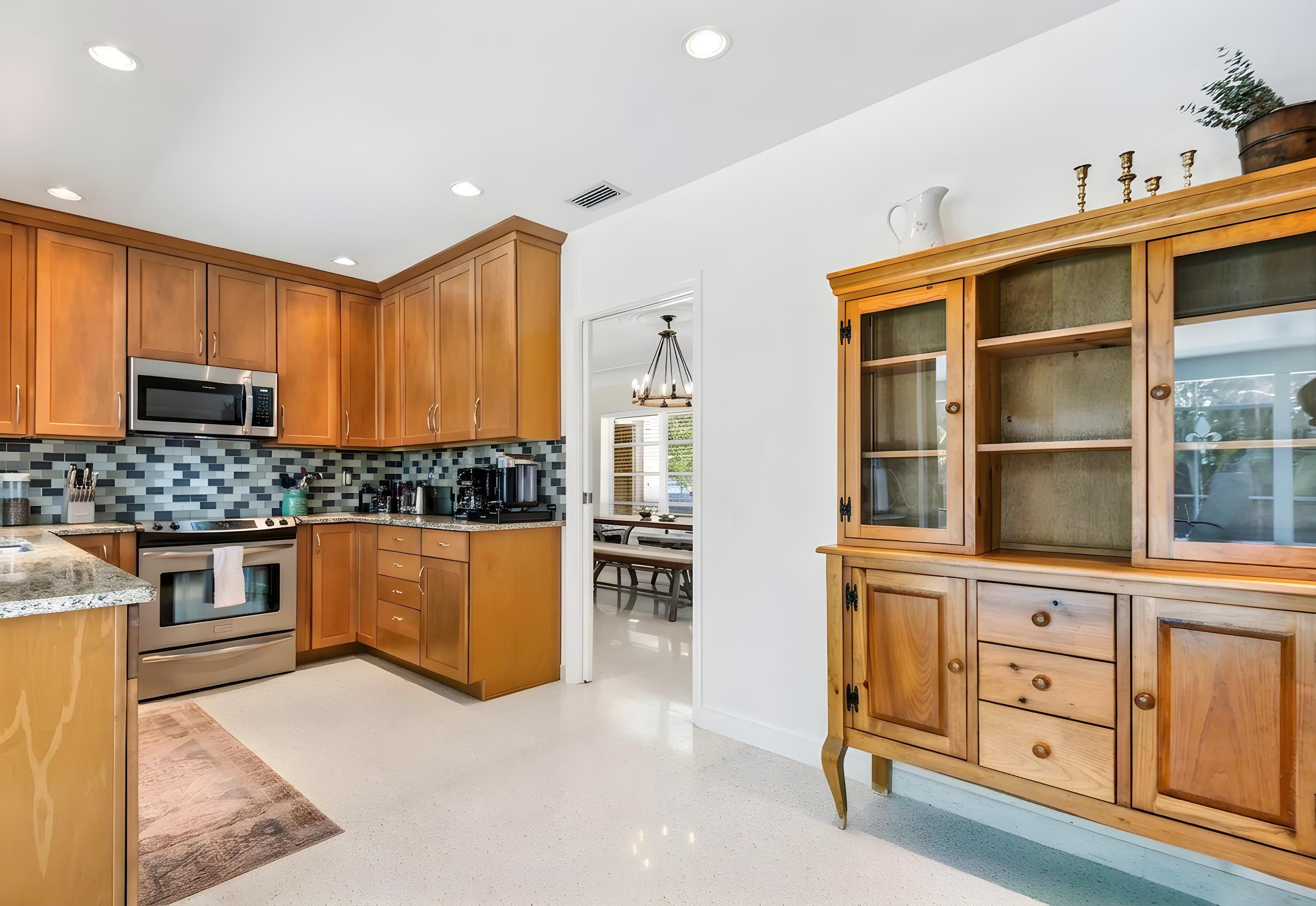 1348 Southwest 4th Street Boca Raton, FL 33486 - Photo 11 of 44 a kitchen with stainless steel appliances granite countertop a stove and a sink