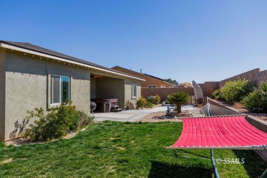 411 Abigail Street Ridgecrest, CA 93555 - Photo 38 of 39 a view of swimming pool with lawn chairs and a yard