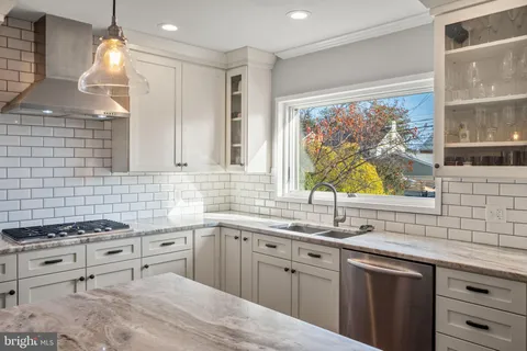 a kitchen with stainless steel appliances a stove sink and cabinets