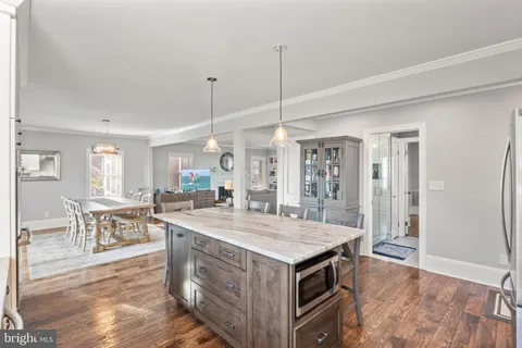 a open kitchen with stainless steel appliances granite countertop a stove and a refrigerator