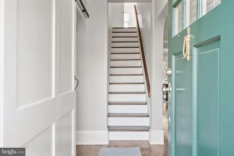 a view of staircase with white walls and windows