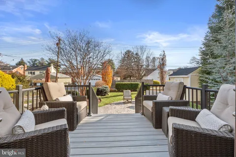a view of a house with backyard sitting area and garden