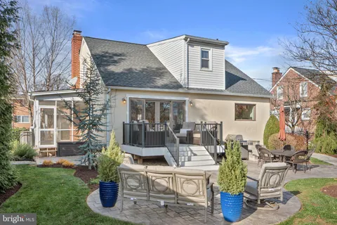 a view of a patio with table and chairs with wooden floor and fence